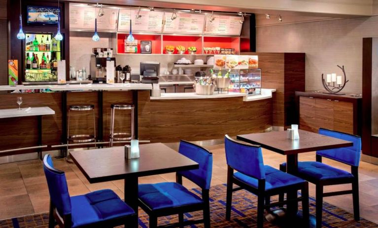 Breakfast area in Sonesta Select Boston Danvers, with seating at small tables or tall bar stools, and a range of healthy options.