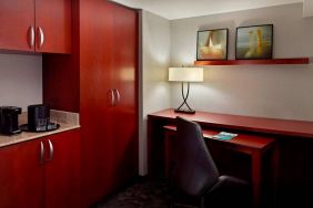 Sonesta Select Atlanta Cumberland Galleria guest room workspace, including desk, chair, and lamp.