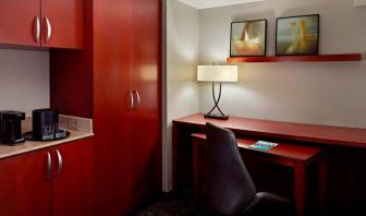 Sonesta Select Atlanta Cumberland Galleria guest room workspace, including desk, chair, and lamp.