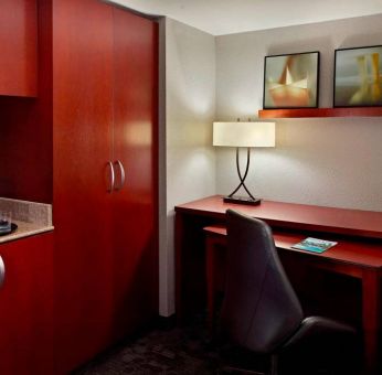 Sonesta Select Atlanta Cumberland Galleria guest room workspace, including desk, chair, and lamp.