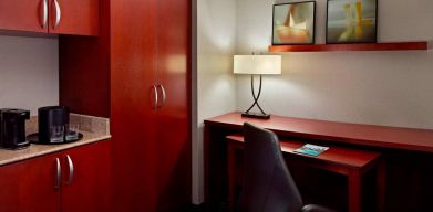 Sonesta Select Atlanta Cumberland Galleria guest room workspace, including desk, chair, and lamp.