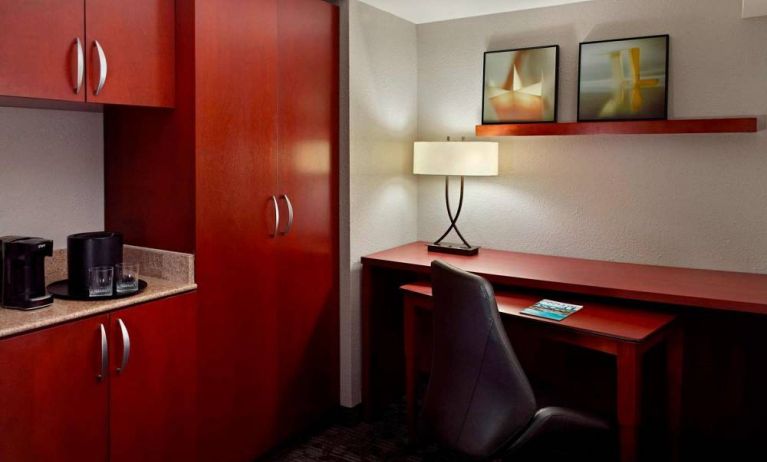 Sonesta Select Atlanta Cumberland Galleria guest room workspace, including desk, chair, and lamp.