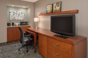 Sonesta Select Seattle Bellevue Redmond guest room workspace, featuring desk and chair, plus TV.