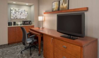 Sonesta Select Seattle Bellevue Redmond guest room workspace, featuring desk and chair, plus TV.