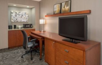 Sonesta Select Seattle Bellevue Redmond guest room workspace, featuring desk and chair, plus TV.