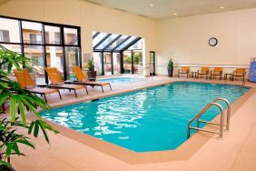 Sonesta Select Seattle Bellevue Redmond’s indoor pool has an adjacent hot tub and nearby loungers and chairs.