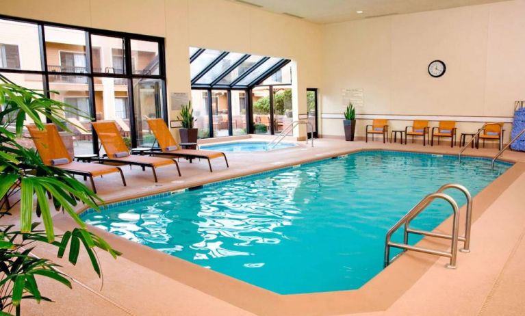 Sonesta Select Seattle Bellevue Redmond’s indoor pool has an adjacent hot tub and nearby loungers and chairs.