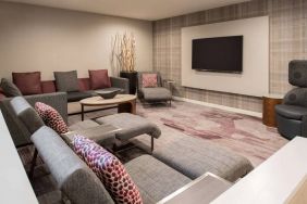 The lobby in Sonesta Select Seattle Bellevue Redmond features an enormous television, comfortable seating and coffee tables.