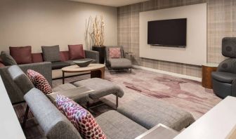 The lobby in Sonesta Select Seattle Bellevue Redmond features an enormous television, comfortable seating and coffee tables.