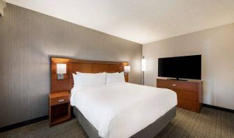 Sonesta Select San Jose Airport double bed guest room, including a large widescreen television.