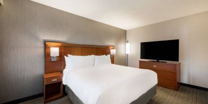 Sonesta Select San Jose Airport double bed guest room, including a large widescreen television.