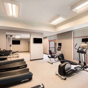 Sonesta Select San Jose Airport’s fitness center is equipped with a range of exercise machines and a wall-mounted TV.