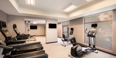 Sonesta Select San Jose Airport’s fitness center is equipped with a range of exercise machines and a wall-mounted TV.