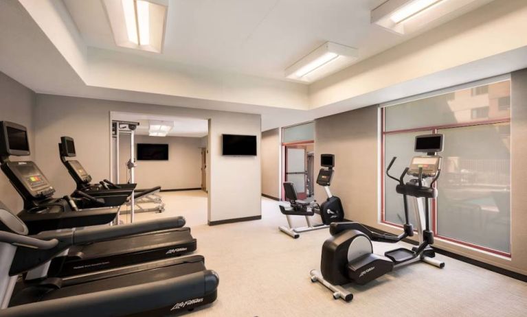 Sonesta Select San Jose Airport’s fitness center is equipped with a range of exercise machines and a wall-mounted TV.