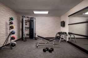 Sonesta Select Charlotte University Research Park’s fitness center is equipped with free weights, a bench, wall-mounted TV, and gym balls.