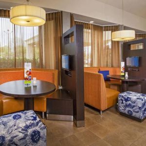 The hotel’s meeting pods provide comfortable seating with televisions and coffee tables for guests to socialize and work.