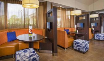 The hotel’s meeting pods provide comfortable seating with televisions and coffee tables for guests to socialize and work.