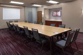 Meeting room in Sonesta Select Boston Milford, furnished with seating for 16 attendees, a long table, and a whiteboard.