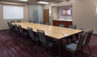 Meeting room in Sonesta Select Boston Milford, furnished with seating for 16 attendees, a long table, and a whiteboard.