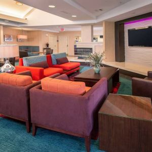 The hotel’s lobby lounge features comfortable chairs facing a widescreen, wall-mounted TV, with coffee tables close at hand.