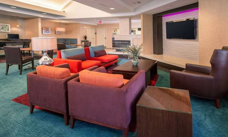 The hotel’s lobby lounge features comfortable chairs facing a widescreen, wall-mounted TV, with coffee tables close at hand.