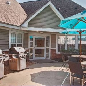 The hotel’s patio area includes shaded tables and chairs, as well as multiple barbecues.