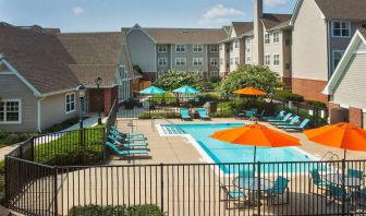 Sonesta ES Suites Baltimore BWI Airport’s outdoor pool is ringed by a fence, within which there are sun loungers, plus shaded tables and chairs.