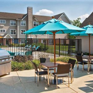 The hotel’s patio has shaded tables and chairs next to a barbecue, with the swimming pool only steps away.