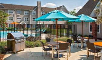 The hotel’s patio has shaded tables and chairs next to a barbecue, with the swimming pool only steps away.