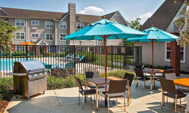 The hotel’s patio has shaded tables and chairs next to a barbecue, with the swimming pool only steps away.