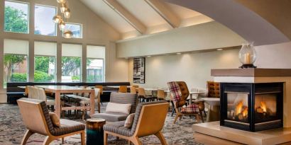 The hotel’s lobby lounge has large windows, extensive seating, coffee tables, and a fireplace.