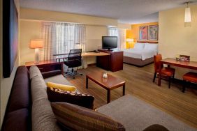 Sonesta ES Suites Allentown Bethlehem Airport double bed guest room, featuring workspace desk and chair, plus sofa and TV.