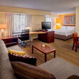 Sonesta ES Suites Allentown Bethlehem Airport double bed guest room, featuring workspace desk and chair, plus sofa and TV.