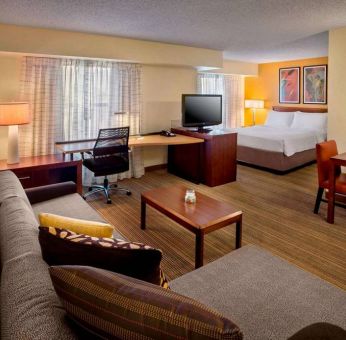 Sonesta ES Suites Allentown Bethlehem Airport double bed guest room, featuring workspace desk and chair, plus sofa and TV.