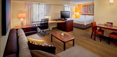 Sonesta ES Suites Allentown Bethlehem Airport double bed guest room, featuring workspace desk and chair, plus sofa and TV.