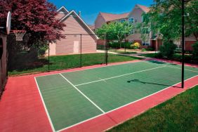 The hotel’s basketball court is located next to the patio, with lush lawns on either side.