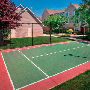 The hotel’s basketball court is located next to the patio, with lush lawns on either side.