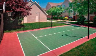 The hotel’s basketball court is located next to the patio, with lush lawns on either side.