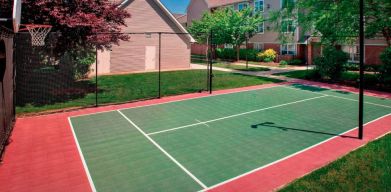 The hotel’s basketball court is located next to the patio, with lush lawns on either side.