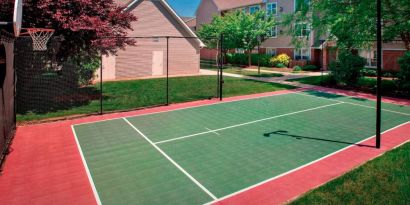 The hotel’s basketball court is located next to the patio, with lush lawns on either side.