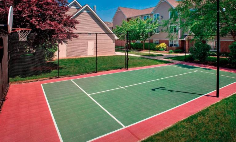 The hotel’s basketball court is located next to the patio, with lush lawns on either side.