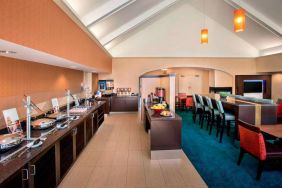 The breakfast area in Sonesta ES Suites Allentown Bethlehem Airport has a mix of table and tall stool seating, and a range of healthy eating options.