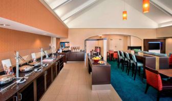 The breakfast area in Sonesta ES Suites Allentown Bethlehem Airport has a mix of table and tall stool seating, and a range of healthy eating options.