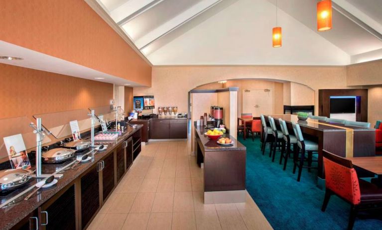 The breakfast area in Sonesta ES Suites Allentown Bethlehem Airport has a mix of table and tall stool seating, and a range of healthy eating options.