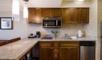 Sonesta ES Suites Chicago Downtown Magnificent Mile - Medical guest room kitchen, equipped with microwave, sink, and breakfast bar.