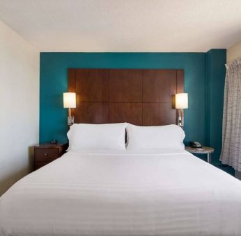 Double bed guest room in Sonesta ES Suites Chicago Downtown Magnificent Mile - Medical, with bedside lamps and window.