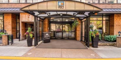 Sonesta ES Suites Chicago Downtown Magnificent Mile - Medical’s exterior has a covered entranceway and numerous potted plants.