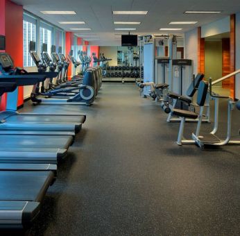 The hotel fitness center is equipped with an extensive array of exercise machines, free weights, and a widescreen television.