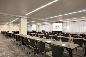 Large meeting room in Royal Sonesta Minneapolis Downtown, with lectern, large screens, and space for seating for several dozen attendees.