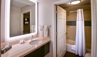 Sonesta ES Suites San Jose Airport guest room bathroom, featuring sink, mirror, bath, shower, and lavatory.